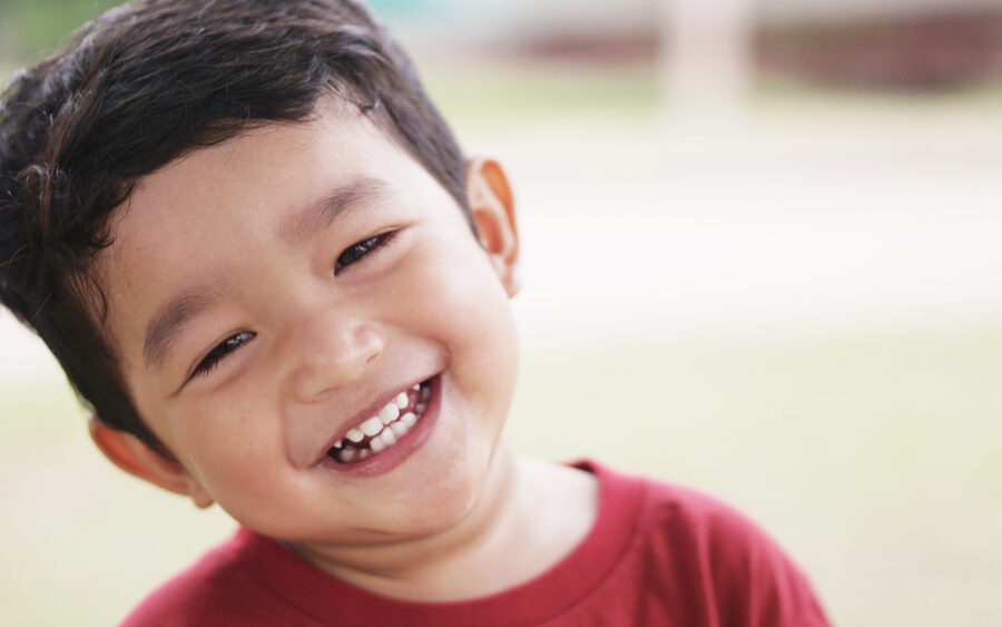 a kid smiling after a consultation on gum disease